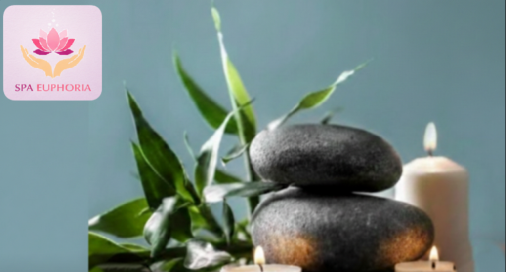 Spa Euphoria logo with bamboo, river stones, and a lit candle for relaxation and skincare services in Gahanna, Ohio